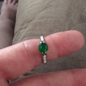 Silver ring with a deep green stone.